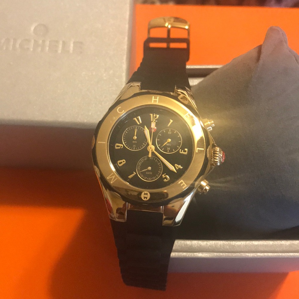 Michelle black and gold silicone band watch.